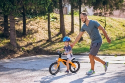 Father teaching his little son to ride a bicycle
